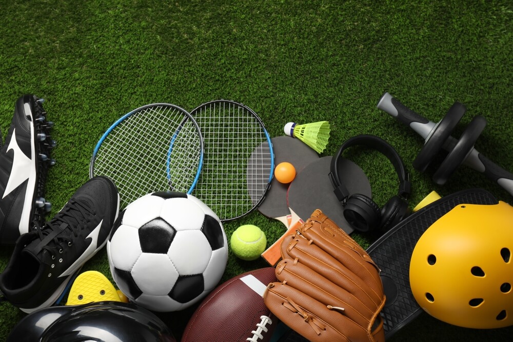 Different,Sports,Equipment,On,Green,Grass,,Flat,Lay