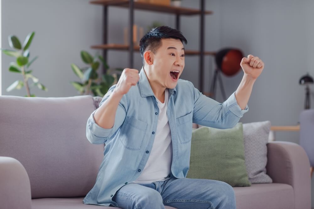 Photo,Of,Positive,Astonished,Japanese,Man,Raise,Fists,Celebrate,Victory